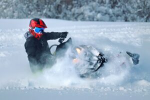 a person riding a snowmobile in the snow